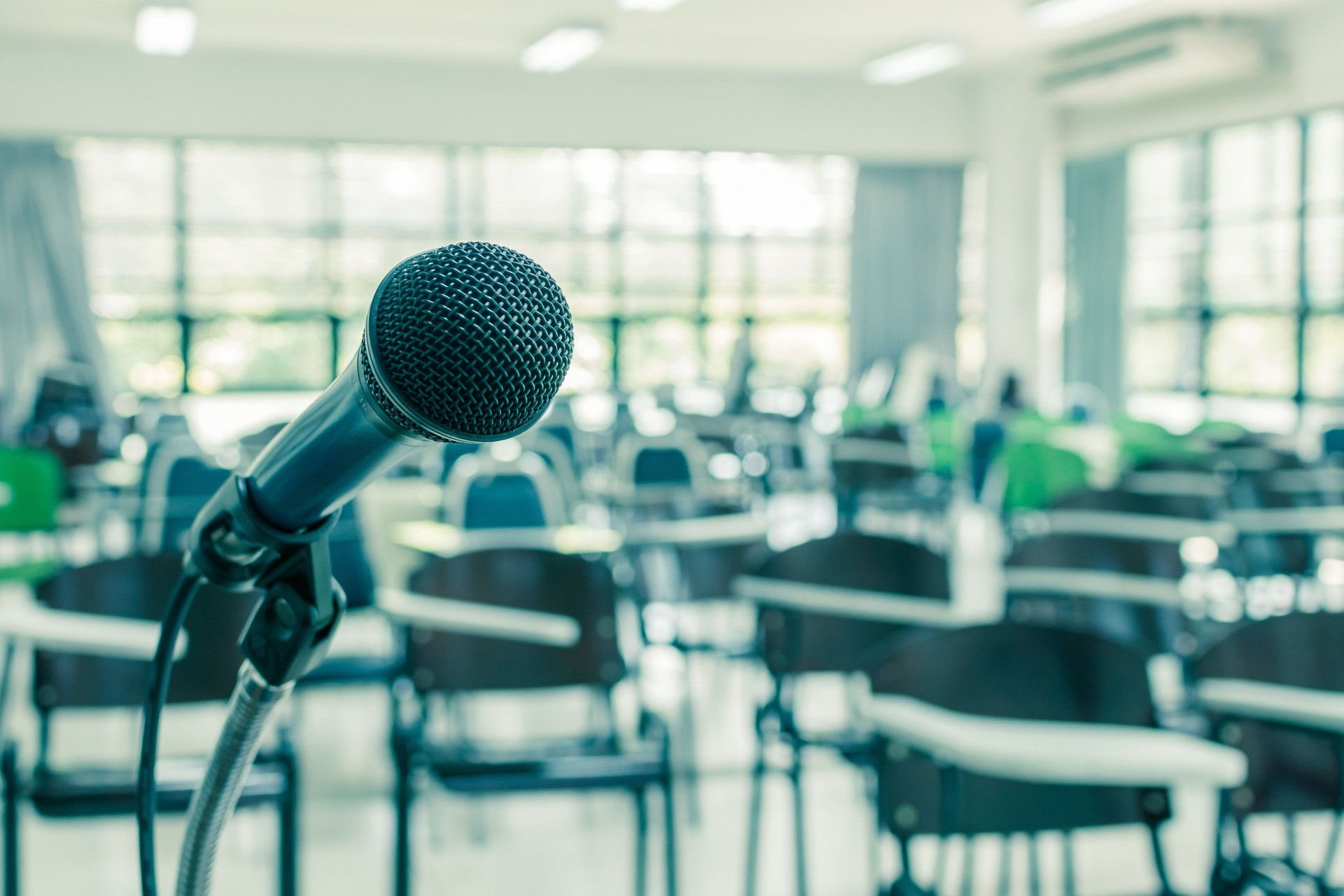 Microphone voice speaker in school lecture hall, seminar meeting room or educational business conference event for host, teacher or coaching mentor